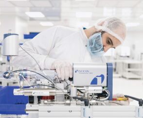 A technician in a cleanroom using a Transpector APX residual gas analyzer