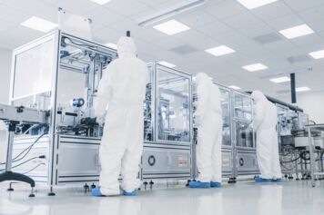 Technicians working in a semiconductor factory Technicians working in a semiconductor factory