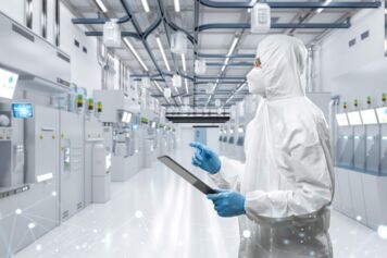 Technician in a semi fab looking at equipment