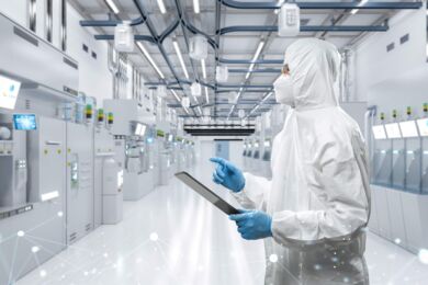 Technician in a semi fab looking at equipment