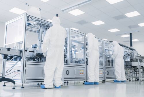 Technicians working in a semiconductor factory Technicians working in a semiconductor factory