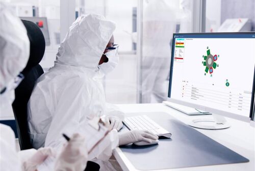 An engineer in a semi fab is using the FabGuard process monitoring and fault detection software system on a computer
