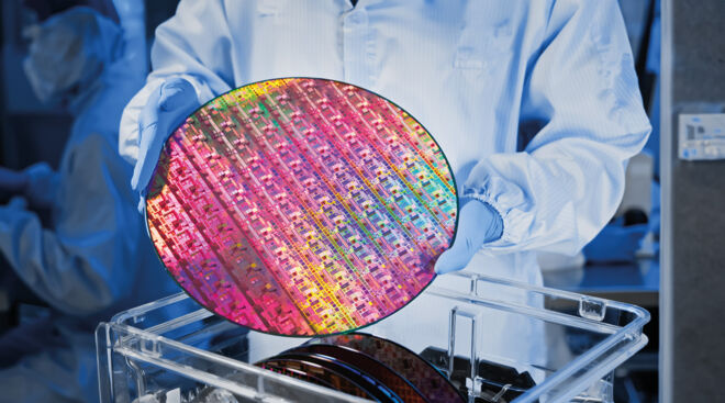 operator holds wafer semiconductor manufacturing