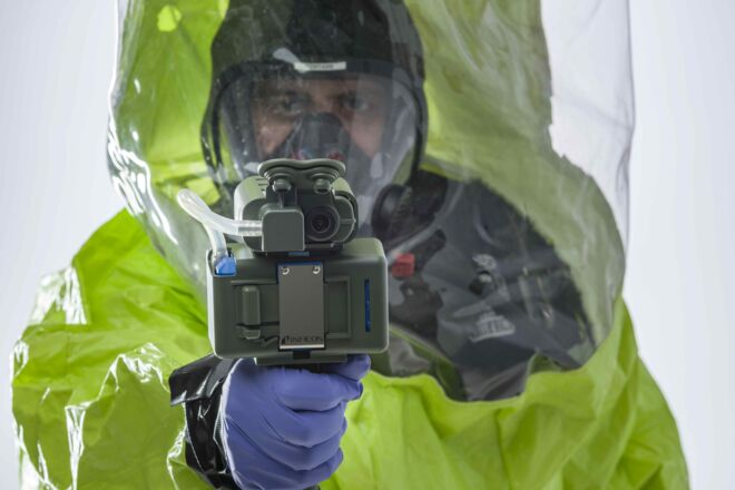 First responder in PPE holding the HAPSITE&reg; CDT Remote Sample Collector